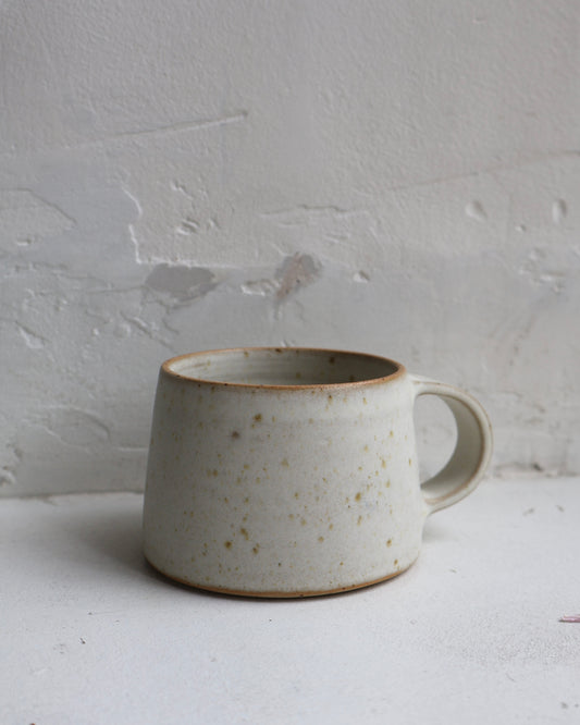 Hand-thrown medium tapered cup in white speckled stoneware, glazed in a smooth matte white finish. Designed by Ela Grima in Malmö, Sweden