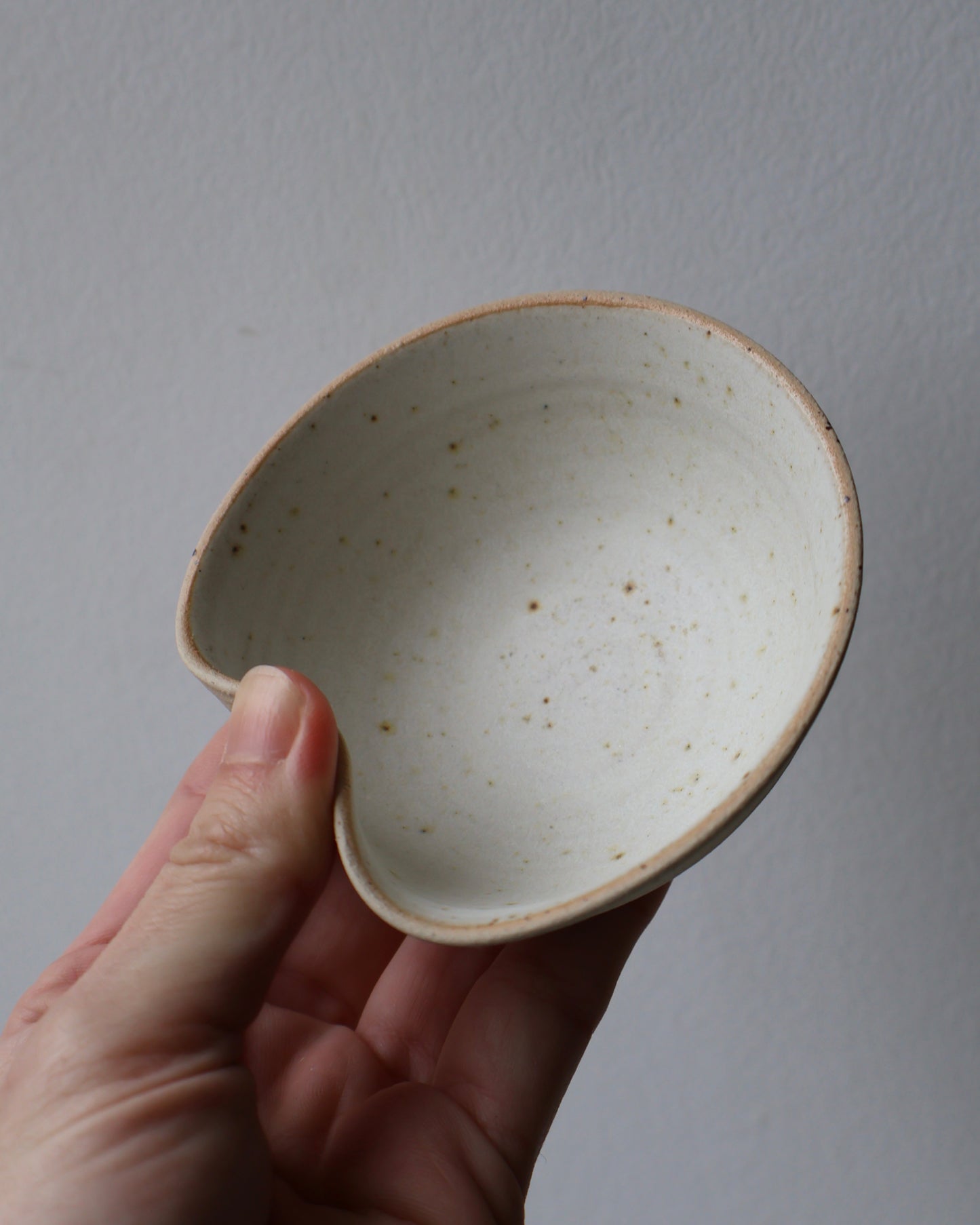 Handcrafted ceramic sushi bowl with matte creamy white glaze and integrated chopstick rest by Ela Grima