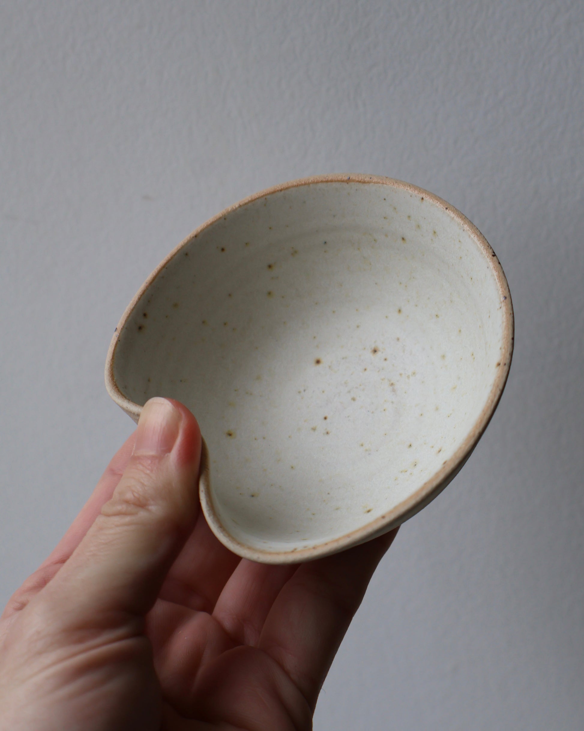 Handcrafted ceramic sushi bowl with matte creamy white glaze and integrated chopstick rest by Ela Grima